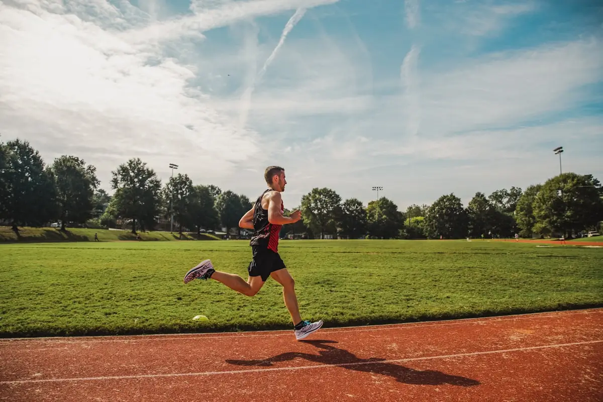Athlete rowing hard on an outdoor rowing machine at full effort during an endurance session