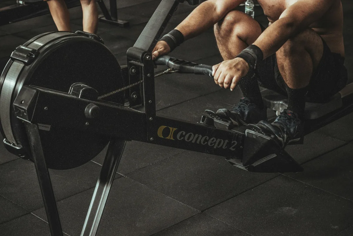 Athlete training on a Concept2 rowing machine, a Hyrox station