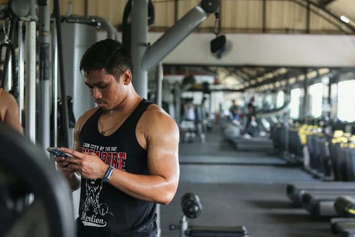 Athlete using a fitness app on a phone and Apple Watch
