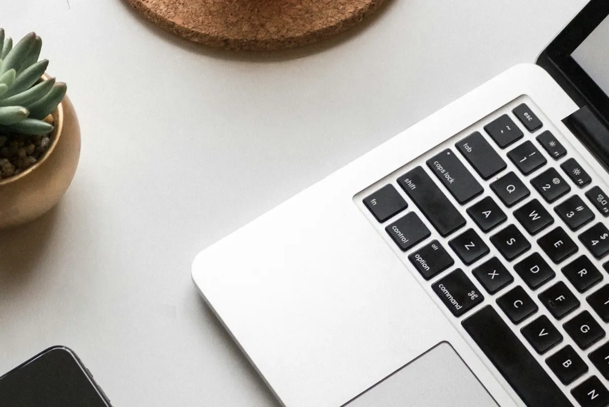 A phone and laptop on a desk, the everyday screens a browser timer opens on