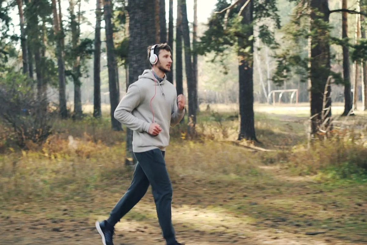 A runner training outdoors with earphones for voice coaching cues